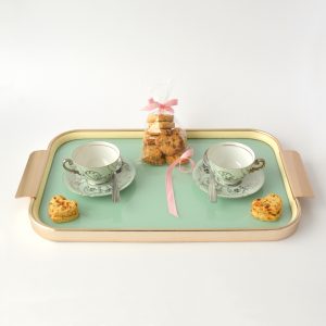 Photo of a tray with vintage teacups and heart shaped biscuits