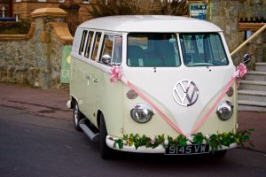 Photo of a VW camper van decorated with ribbons and flowers